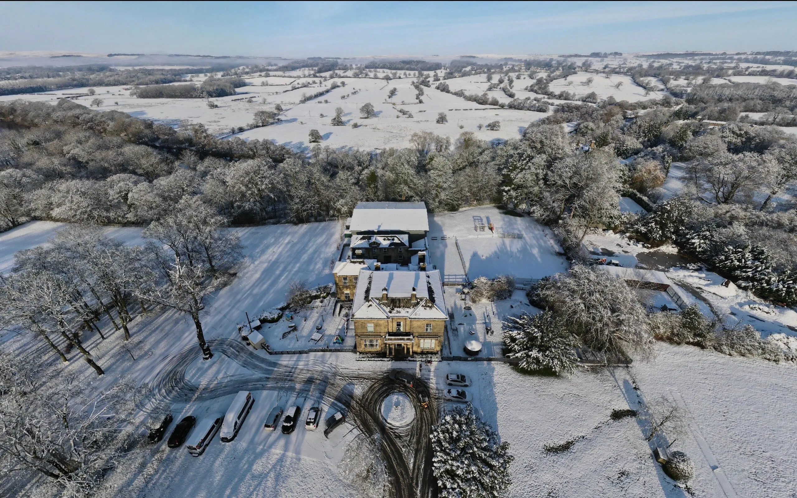 Aerial view of snow blanketed grounds of Ghyll Royd estate in Yorkshire