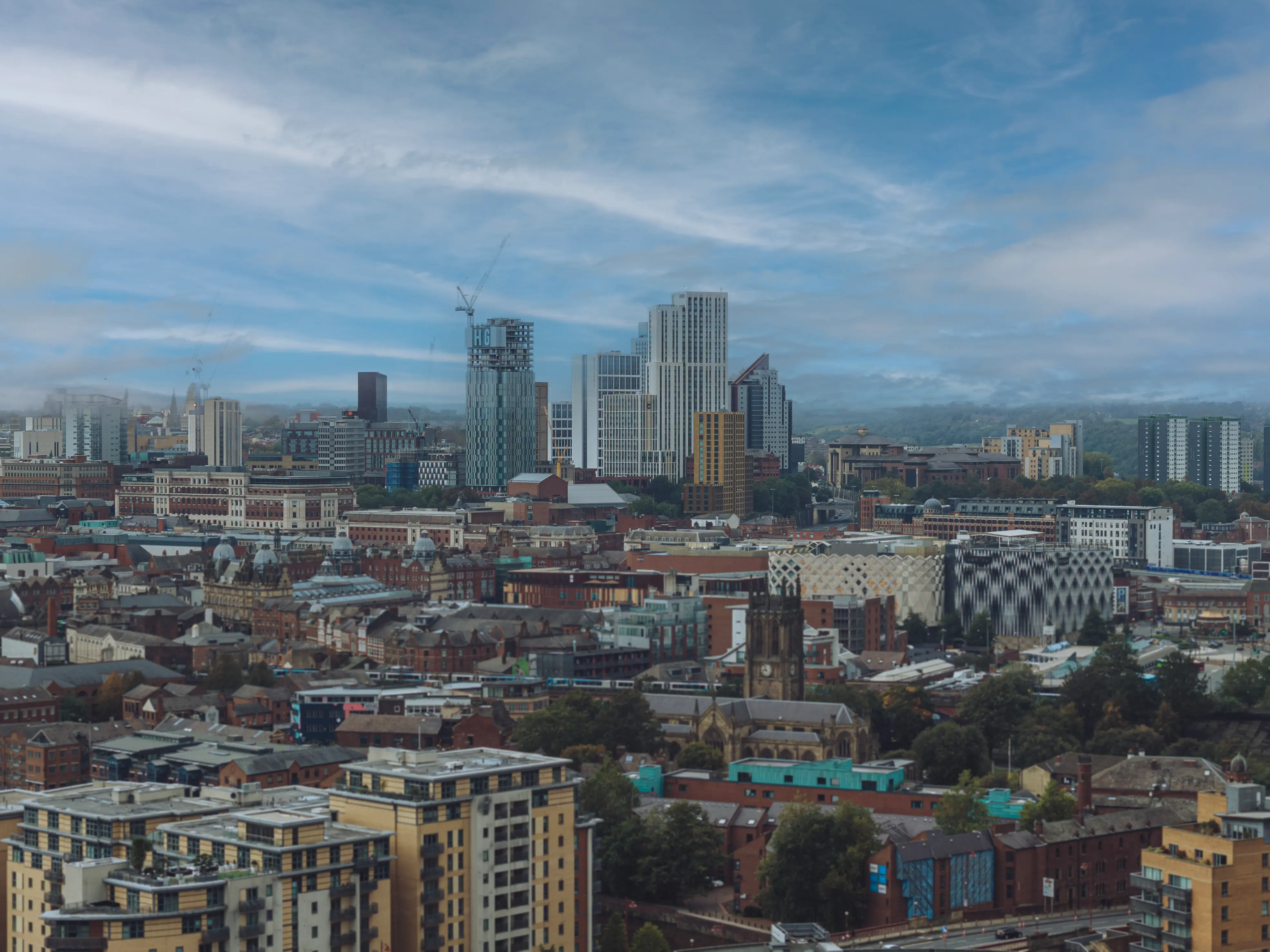 Cinematic aerial perspective of Leeds city centre skyscrapers and architectural skyline