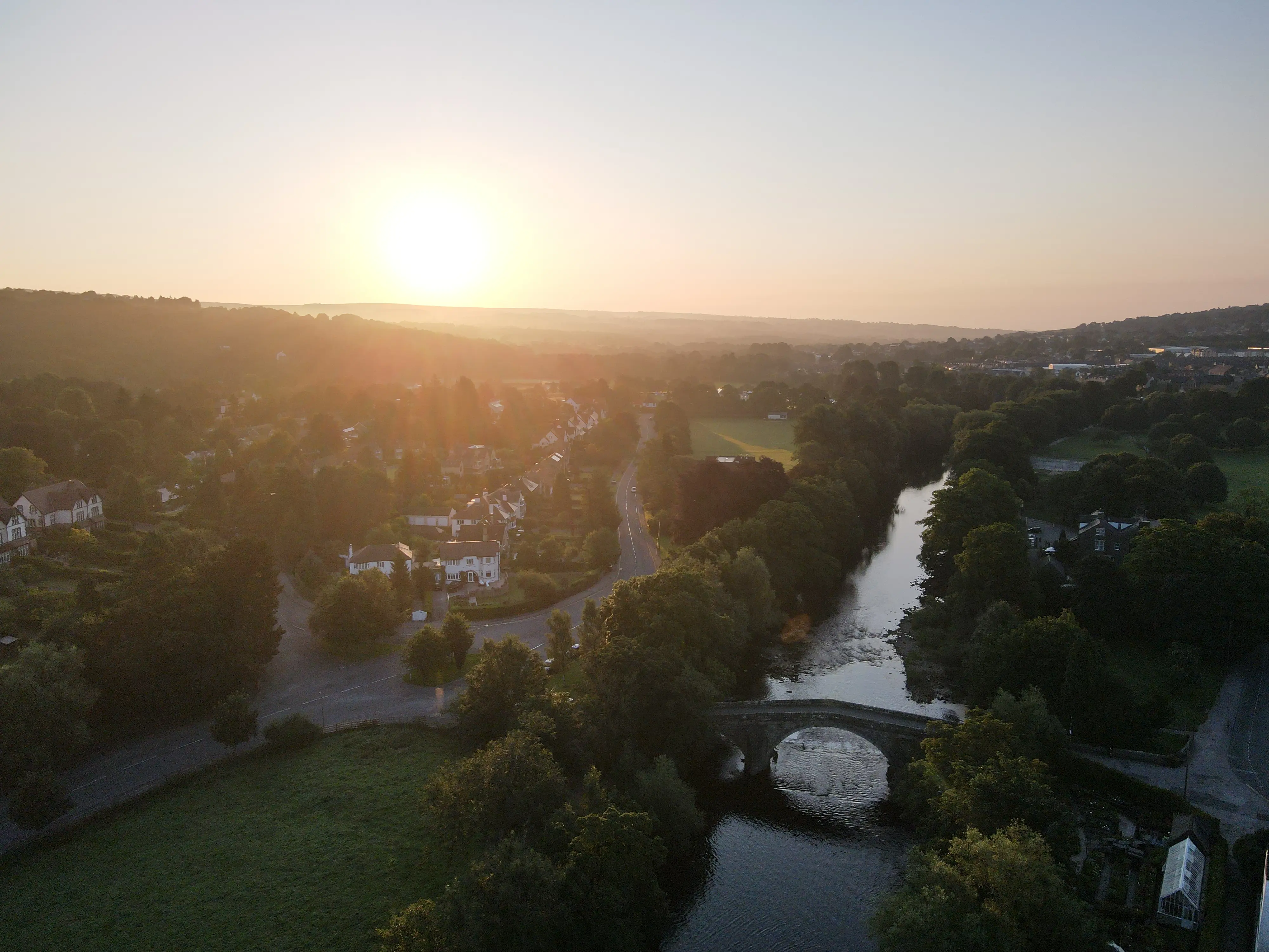 Aerial view of the historic medieval stone Old Bridge spanning the River Wharfe in Ilkley
